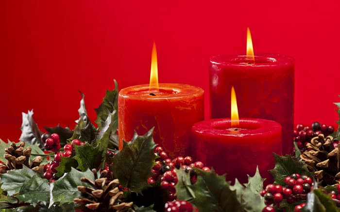 candles decorated with holly